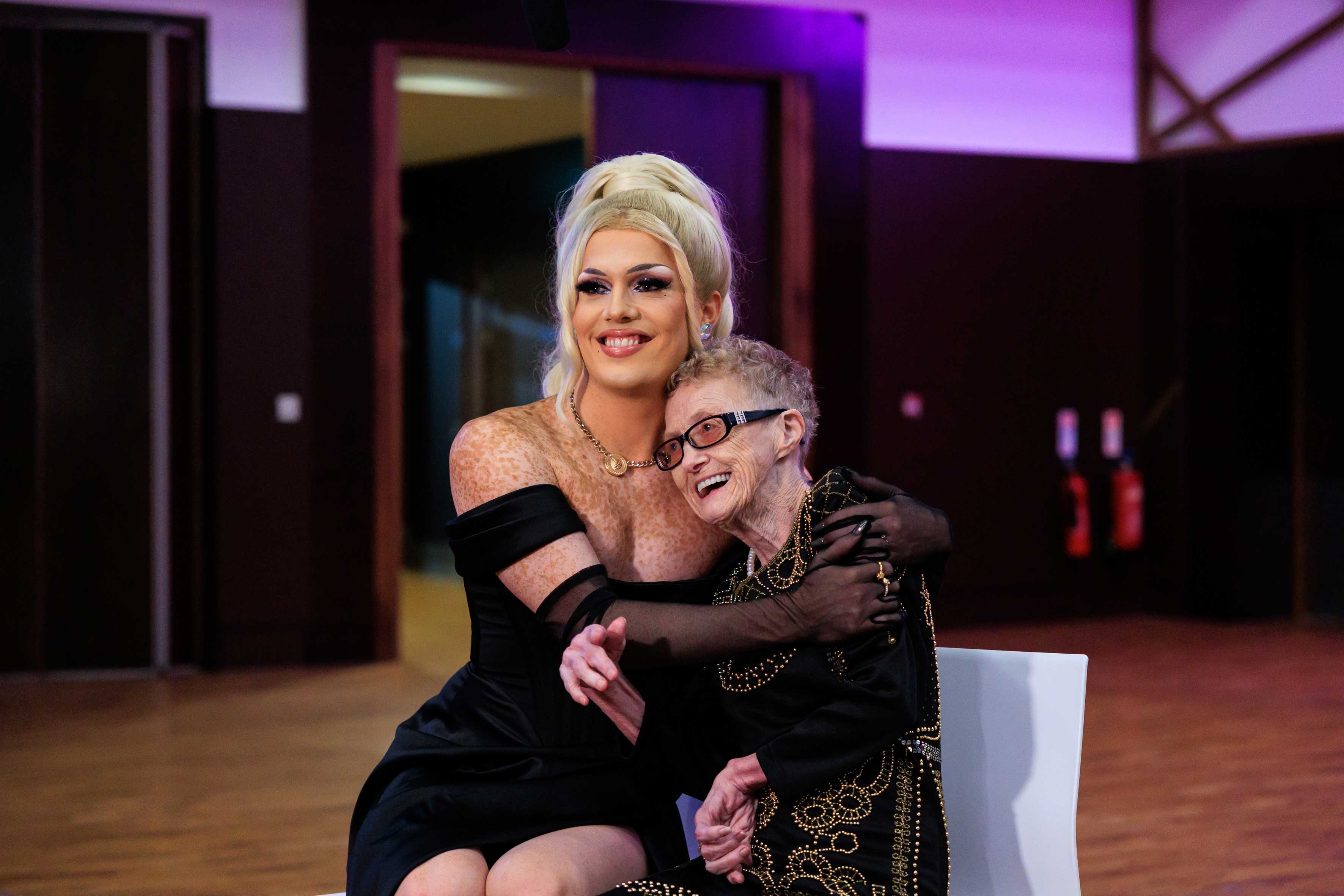 A woman hugging an older woman