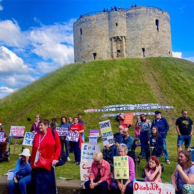 A group of activists from Reverse the Ban York hold up placards in front of York Castle.